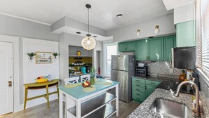 A modern kitchen with green cabinets, a stainless steel refrigerator, and a granite countertop. - Spacious 5-bedroom Pineapple House in wonderful Pikesville/10PPL/Pets/ WiFi (Pikesville)