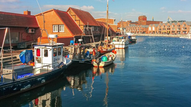 A harbor with boats docked, buildings with red roofs, and a clear sky. - Pet friendly apartment in Hohen Wieschendorf (Hohen Wieschendorf)