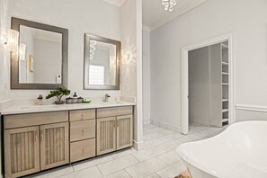 Bathroom features a bathtub, double vanity, and walk-in closet.
