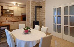 Enjoy meals in the spacious kitchen with a central island, stove, and dining area for four.