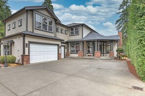 A two-story house with a garage, a covered entryway, and a well-maintained driveway. - Luxury Lake Waterfront Friendly Retreat (Federal Way)
