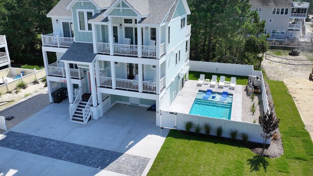 A multi-story beachfront property with a swimming pool and outdoor seating. - Oceanside, ELEV, Priv Pool, Comm Amenities, Dogs Welcome-BH7, O'Buoy (Corolla)