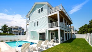 A two-story house with a swimming pool, a covered patio, and a fenced yard. - Oceanside, ELEV, Priv Pool, Comm Amenities, Dogs Welcome-BH7, O'Buoy (Corolla)