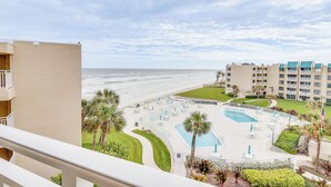 A hotel with a pool area, a beach view, and a multi-story building with balconies. - Top-floor Condo w/ Stunning Views, 2 Pools & More (New Smyrna Beach)