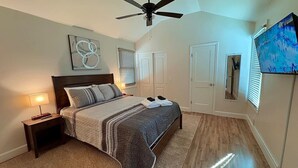 A bedroom with a bed, nightstand, ceiling fan, and a television on the wall. - 3Min To Parris Island. Pets Yes (Port Royal)