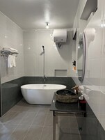 Separate bathtub and shower, slippers, soap, shampoo