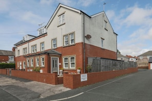 A two-story residential building with a brick facade, a gated entrance, and a 'Strictly Private Residents Only' sign. - House - Sleeps 10 - Parking - WiFi (Barrow-in-Furness)