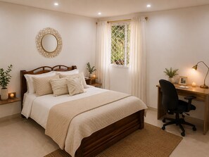 Un dormitorio con una cama de madera, mesitas de noche con velas, un escritorio con una silla y una ventana con cortinas.