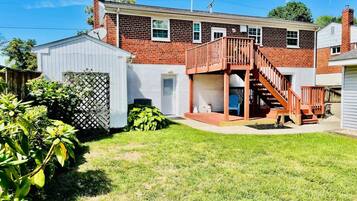 A two-story house with a wooden deck and a garage.