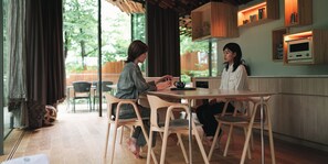 Una cocina moderna con armarios de madera, horno empotrado y un comedor con una mesa redonda y sillas.