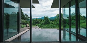 A modern infinity pool with a view of lush greenery and mountains. - Snow Peak FIELD SUITE SPA HEADQUARTERS (Sanjo)
