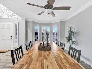 A dining room with a wooden table, chairs, a ceiling fan, and a view through the windows. - Heated Pool and Hot tub in Rowlett/Game Room/Near Lakes (Rowlett)