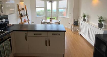 Relaxing modern 2-bed apartment with private parking, a garden & epic sea views.