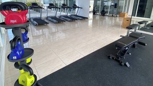 A modern gym with treadmills, weight machines, and kettlebells. - 80m² Luxury Ocean View Apartment PH The Sands, Next to Hilton (Panama City)