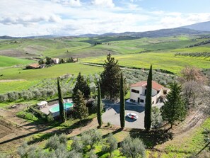 Escape to a serene countryside retreat with a modern two-story house, expansive views, and a swimming pool.