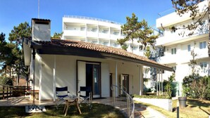 Un edificio moderno con un porche cubierto, mobiliario exterior y vistas despejadas del entorno.