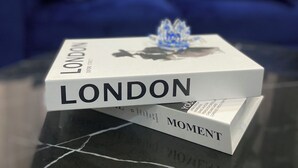 A book titled 'LONDON' on a table with a marble surface. - Stylishly decorated 2-bedroom apartment in a serene lovely environment (Lagos)