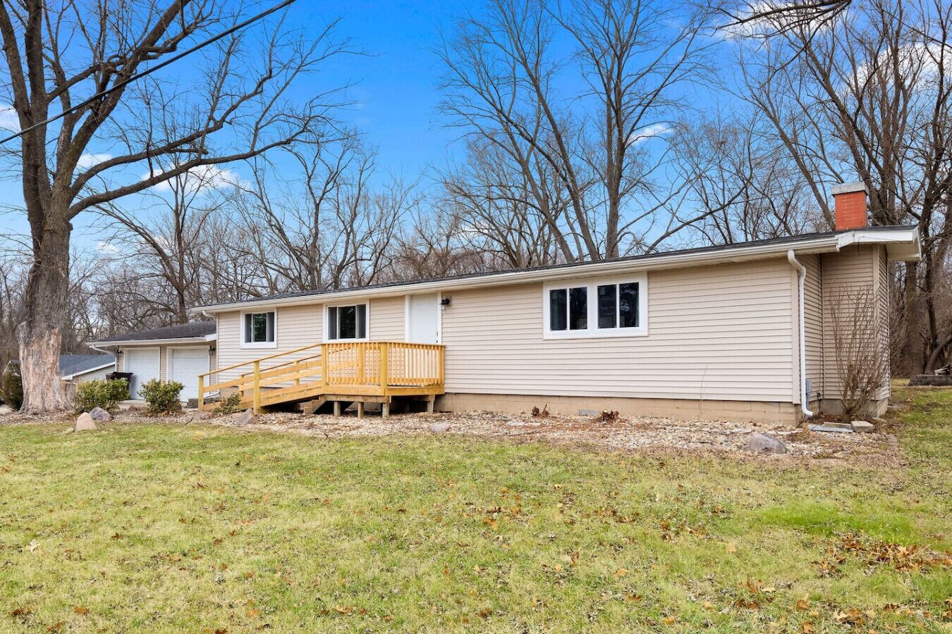 A single-story house with a front deck and a small porch.