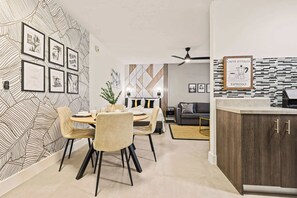 A modern living space with a dining area, a sofa, and a kitchen counter. - Steps from Sand | Coastal Retreat Stylish Studio (Miami Beach)