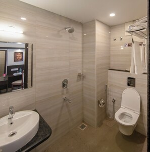 A modern bathroom with a sink, toilet, and shower. - Hotel Dasya Formerly Nice Stay Hotel (Bengaluru)