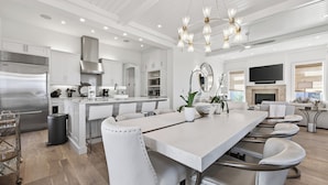 A modern kitchen with white cabinetry, stainless steel appliances, and a large island. - Elevated Vacation Living• Fairmont Inspiration by the Bay (Miramar Beach)