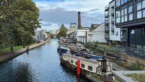 A canal with boats, a pedestrian path, and modern buildings. - Private En-Suite Room | Walk to Angel Station | Near Shoreditch (London)