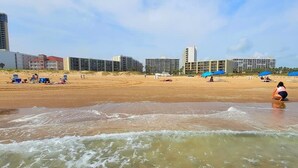 A beach with buildings in the background, a sandy shore, and waves. - Saida Towers Iv #108 2 Bedroom Condo (South Padre Island)
