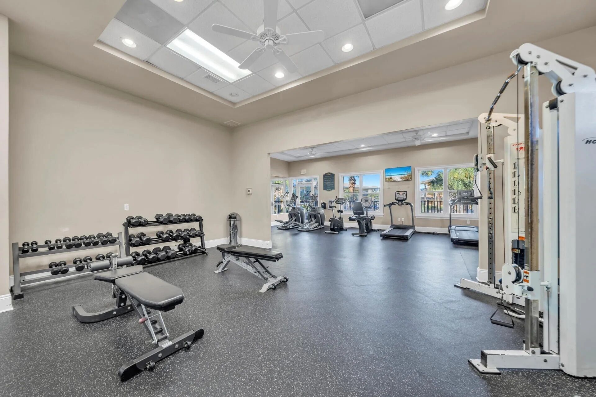 A gym with treadmills, elliptical machines, and weightlifting equipment.