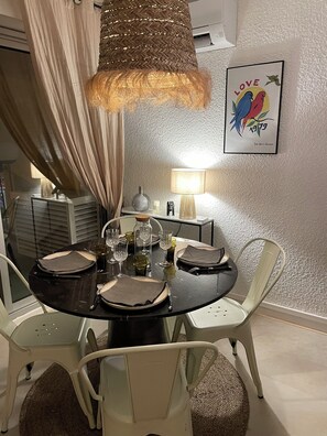 Enjoy a romantic dinner for four at this intimate dining area, complete with a beautifully set table and artwork.