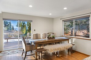 Enjoy meals in this dining area with a view of the snowy landscape through large windows.