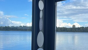 A view through a window with a series of circular objects on the window frame. - Hausboot am Xantener Nordsee (Xanten)
