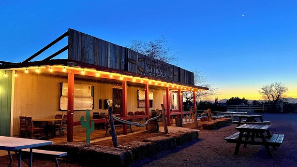 A rustic building with a sign reading "SHORT BRANCH SALOON" and a wooden exterior. - Short Branch Motel (Pahrump)