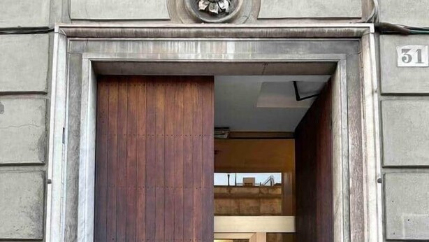 A wooden door with a circular handle, a glass door with a metal frame, and a marble threshold. - Corvetto View (Genoa)