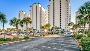 A parking lot with several cars and palm trees. - Absolutely Shore, Navarre Beach (Navarre)