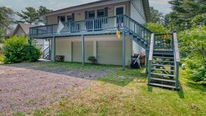 A two-story house with a covered porch and a staircase leading to the upper level. - DePerrys On The Lake Waterfront Access to Lake Superior (Bayfield)