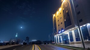 A modern hotel with a prominent entrance, large windows, and a well-lit facade. - Maidan Al Bait (Makkah)