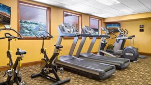 Un centre de remise en forme équipé de tapis de course, d’elliptiques et de vélos d’appartement.