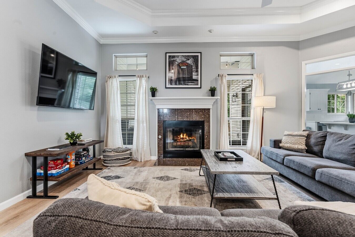 A living room with a fireplace, a television, a sofa, and a coffee table.