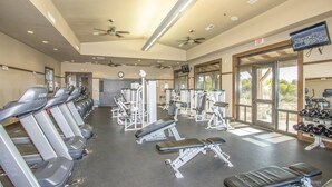A gym with treadmills, weight machines, and dumbbells. - Lovely 3BR ranch home in Maricopa resort community w/ pools, courts, fitness ctr (Maricopa)