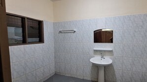 A bathroom with a sink, mirror, towel rack, and a window. - Room-deluxe 2 Bedrooms Apartment In Coto (Cotonou)