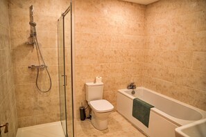 A bathroom with a glass-enclosed shower, a toilet, and a bathtub. - Little Rissington - Barn Six (Little Rissington)