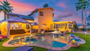 A house with a swimming pool, outdoor furniture, and a covered patio. - Private Guest Suite - Pool, Hot Tub, Cabana, Courtyard & Putting Green (Peoria)