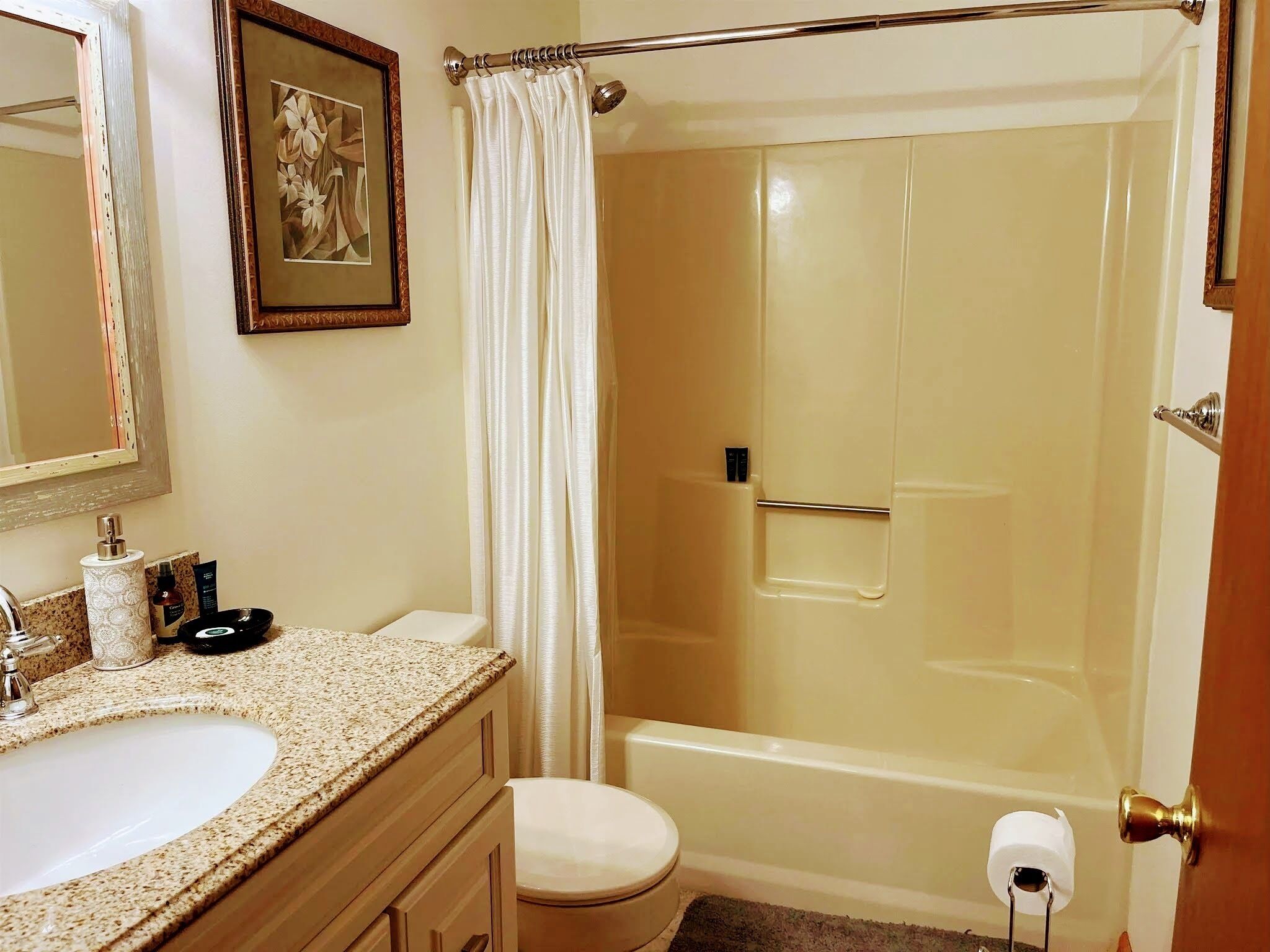 A bathroom with a sink, toilet, and shower.