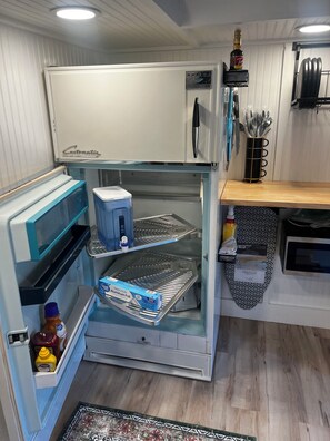 Fridge, microwave, coffee/tea maker, cookware/dishes/utensils