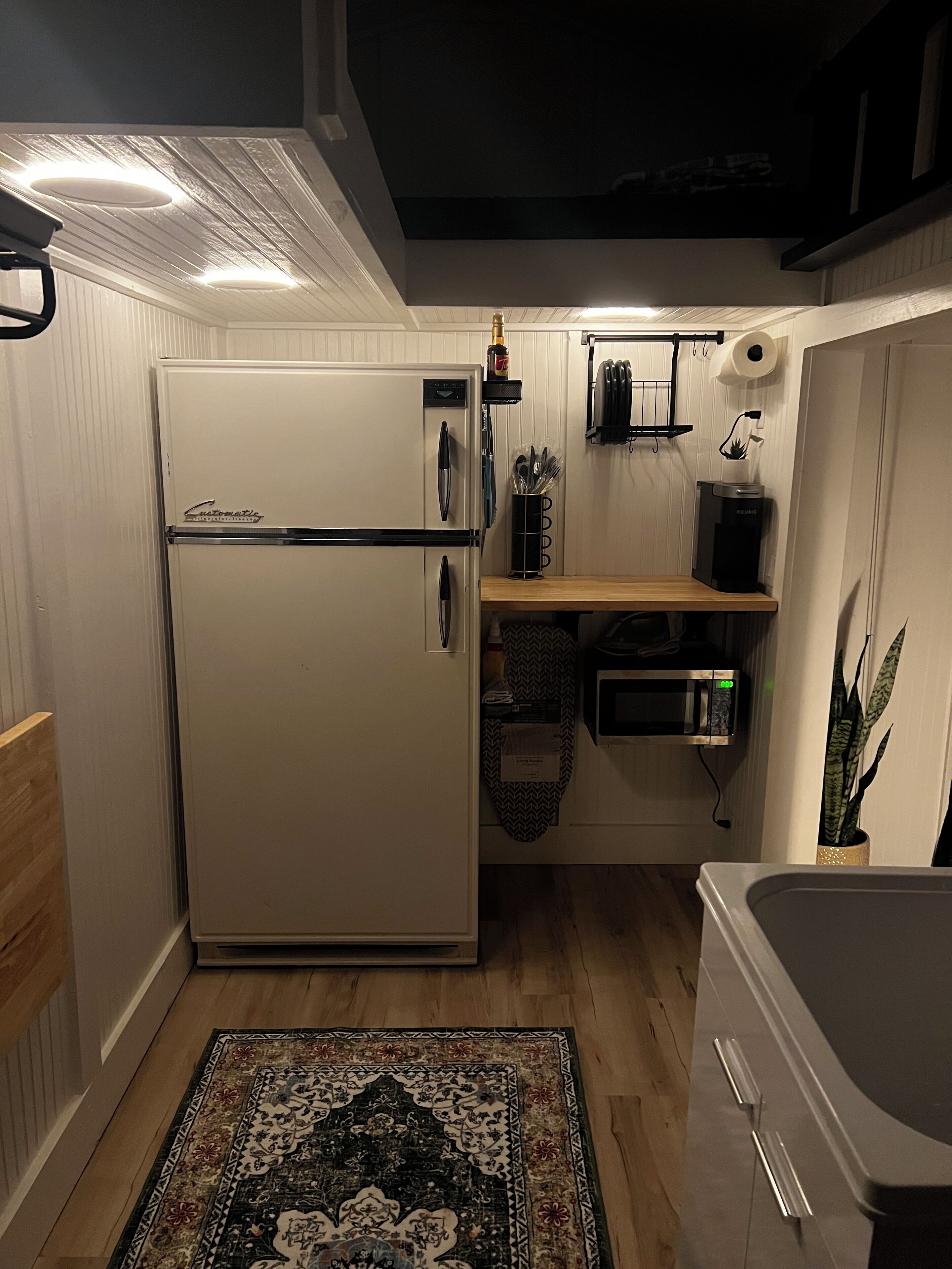 Fridge, microwave, coffee/tea maker, cookware/dishes/utensils