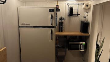 Fridge, microwave, coffee/tea maker, cookware/dishes/utensils