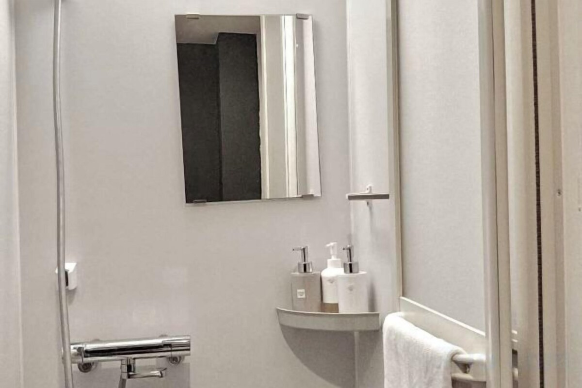 Shower, hair dryer, slippers, towels