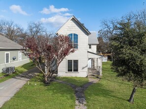 Enjoy a serene atmosphere in this charming home with a large front window and cozy porch.