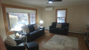 A living room with two sofas, a coffee table, a lamp, and a rug.