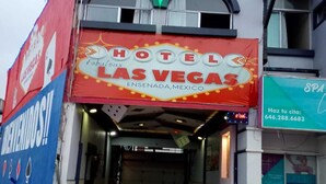A hotel entrance with a sign reading "HOTEL LAS VEGAS" and a phone number. - HOTEL LAS VEGAS (Ensenada)